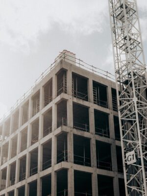 Construction site with half built building and crane in city