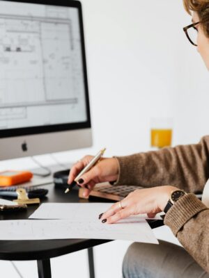 Crop estate agent working with computer in office